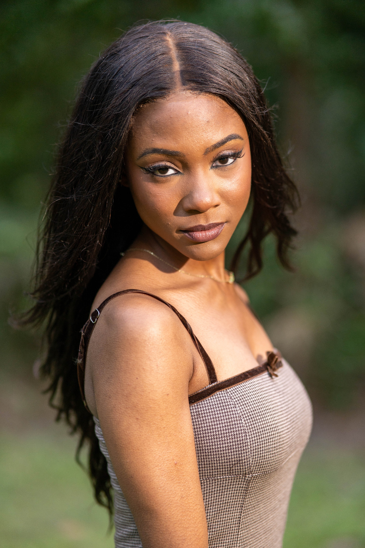 Commercial beauty portrait of Chelsey Moné in natural light with a soft green background